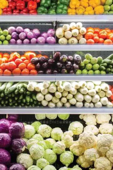 Colorful vegetables neatly stacked in a store, perfect for your anti-inflammatory grocery list