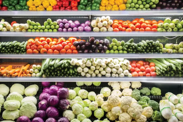 Colorful vegetables neatly stacked in a store, perfect for your anti-inflammatory grocery list
