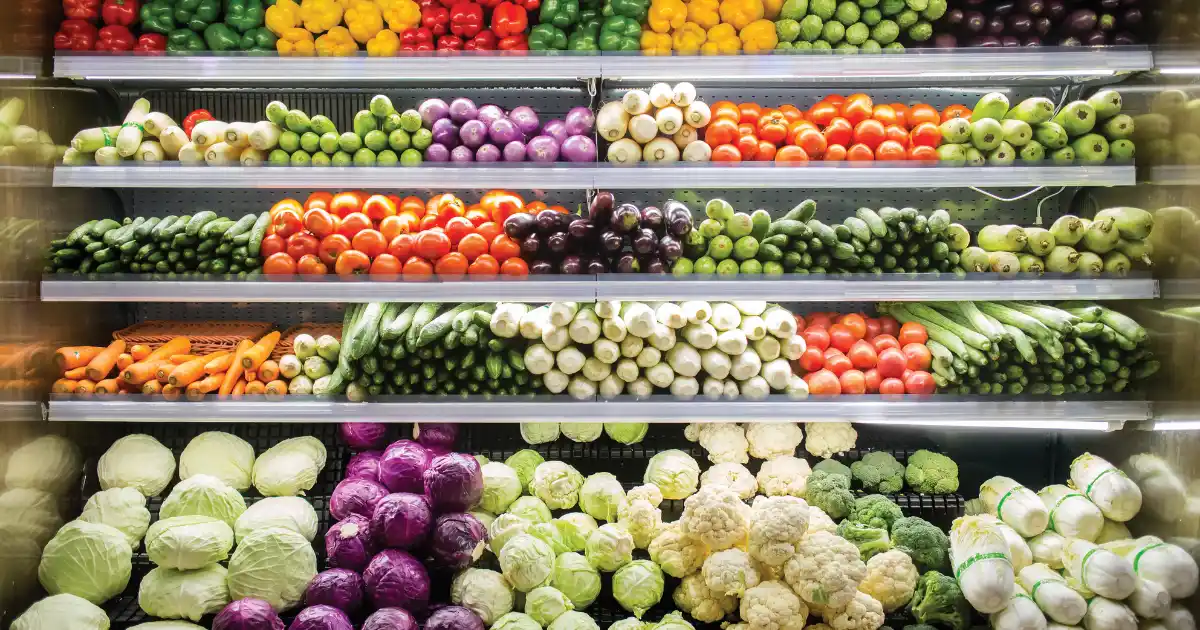 Colorful vegetables neatly stacked in a store, perfect for your anti-inflammatory grocery list