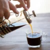 French press coffee being poured into a glass cup raises the question: Is coffee inflammatory?