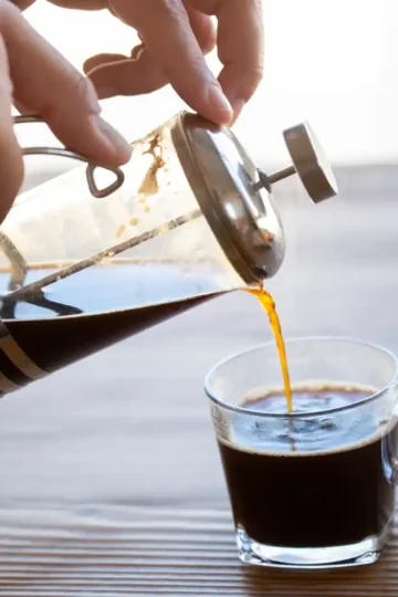 French press coffee being poured into a glass cup raises the question: Is coffee inflammatory?