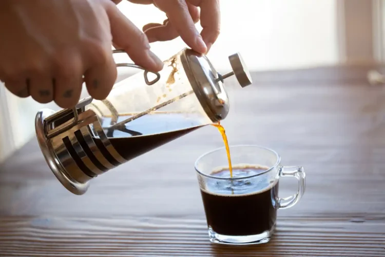 French press coffee being poured into a glass cup raises the question: Is coffee inflammatory?